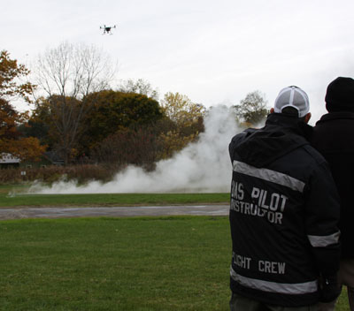 Drone approaching a landing zone through artifical fog